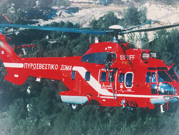 A photograph of the red Super Puma helicopter flying in the air